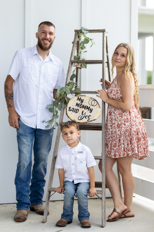 engagement photos with "my mom said yes" sign