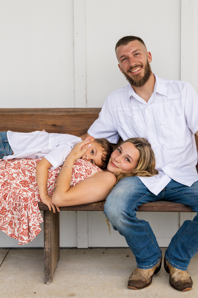 family of 3 on a church pew
