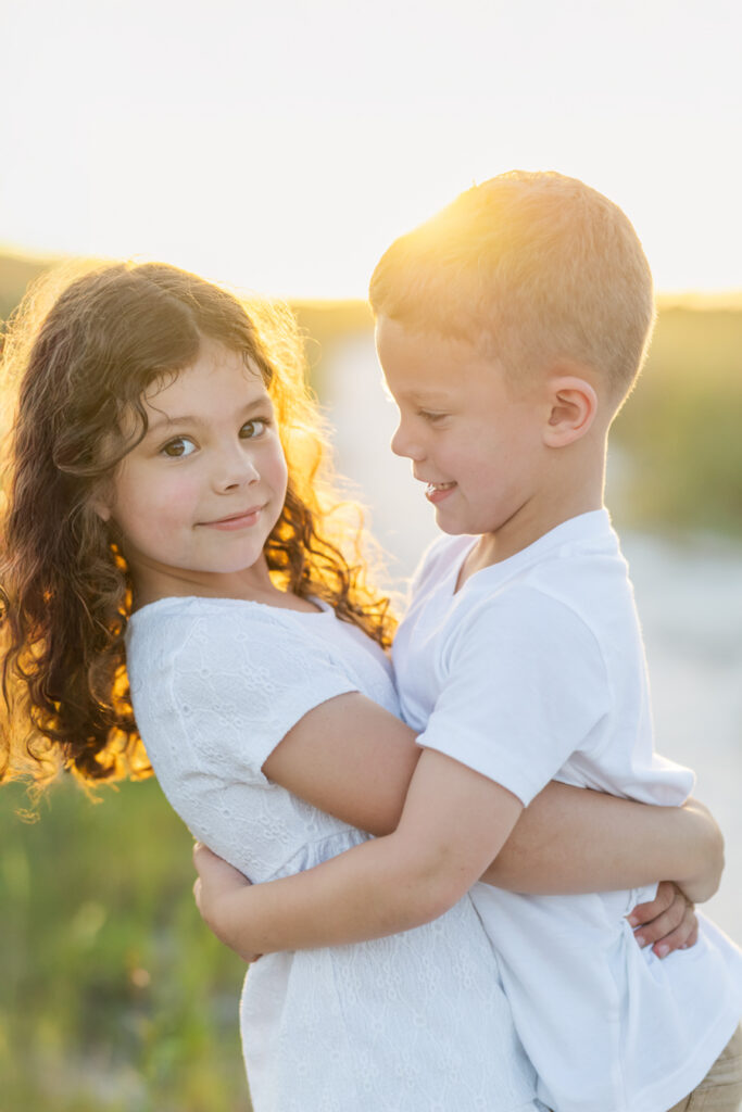 girl holding up her brother