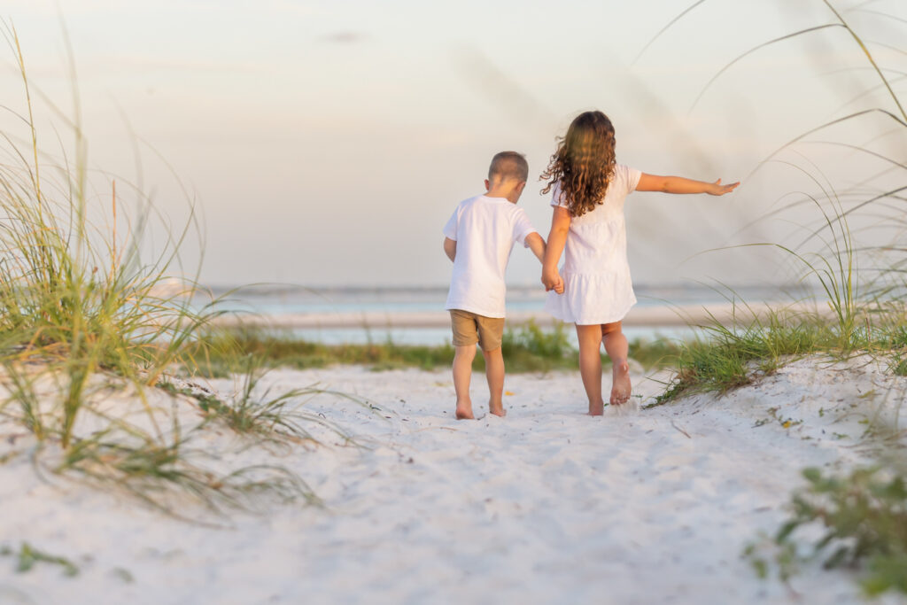 brother and sister exploring the beach