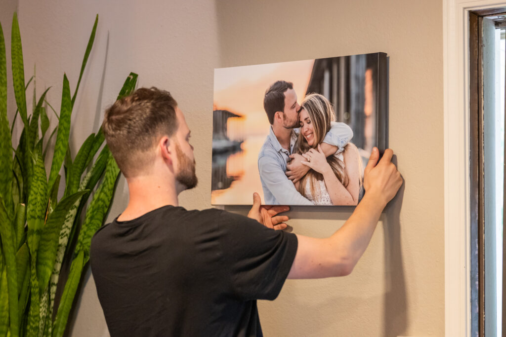 hanging an engagement photo on the wall