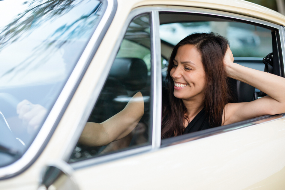 woman smiling in vintage car