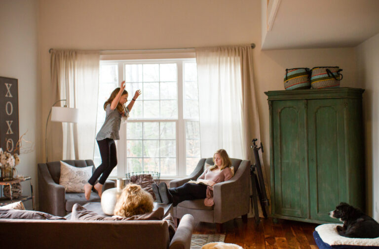 girl jumping off the couch